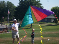 Vancouver back pain free grandpa and grandson playing with a kite